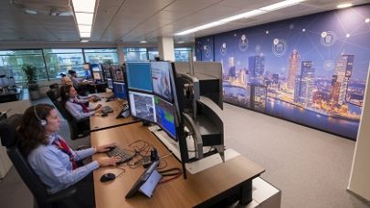 Medewerkers alarmservicecentrale monitoren beveiliging op afstand vanachter 