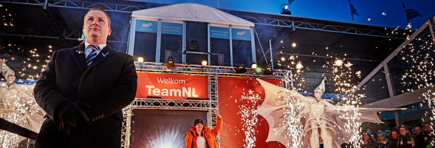 Beveiliger die op wacht staat, terwijl een topsporter het podium op gaat.