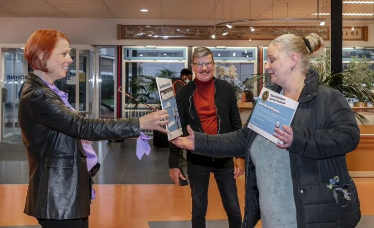 Jonika Keizer overhandigt de waardencheque aan Gom Uitblinker Esmeralda, met op de achtergrond haar leidinggevende
