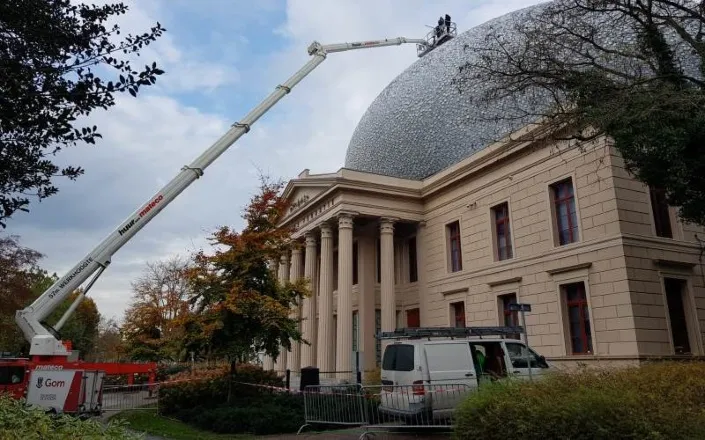 Medewerkers van Gom Specialistische Reiniging reinigen het dak en de koepel van Museum de Fundatie in Zwolle met behulp van een telescoophoogwerker.