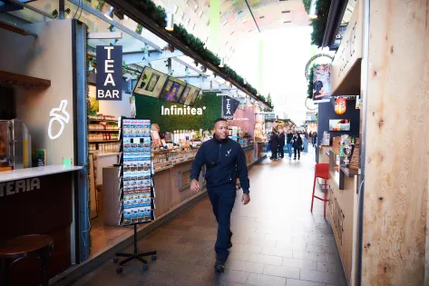 Een retailbeveiliger loopt door de winkelstraat.